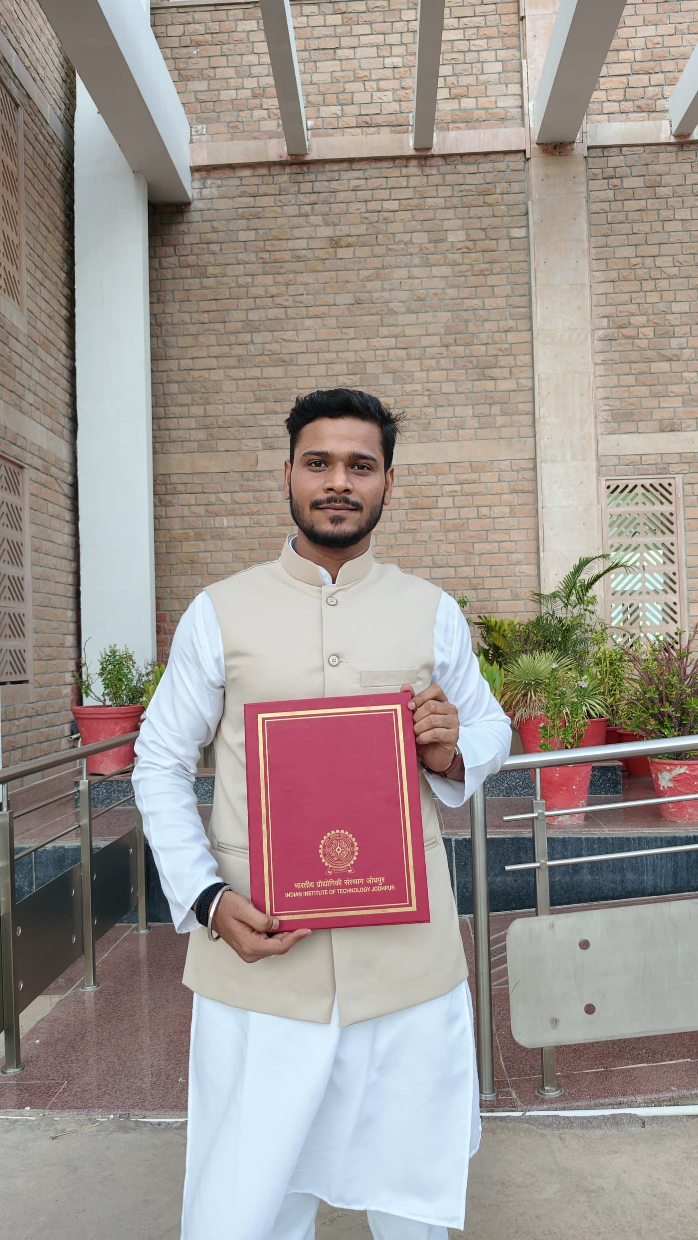 Portrait holding the IIT Jodhpur degree folder