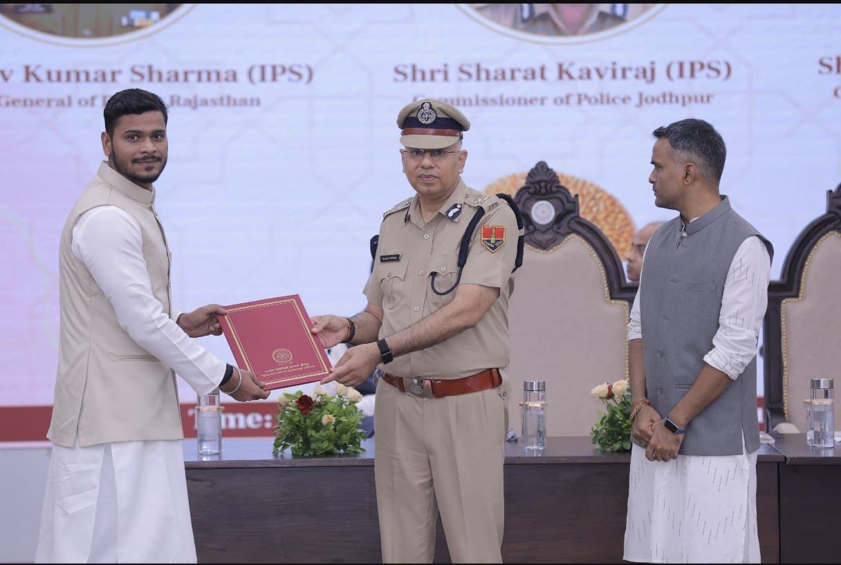 Receiving the Postgraduate Diploma from senior police officials on stage